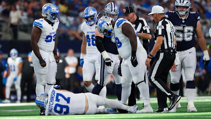 Teammates gather around injured Aidan Hutchinson, a season-ending injury that could disrupt the NFC North race. Teammates gather around injured Aidan Hutchinson, a season-ending injury that could disrupt the NFC North race.