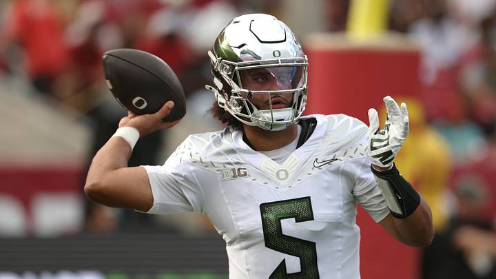 Sep 26, 2026; Los Angeles, California, USA;  Oregon Ducks quarterback Dante Moore (5) throws a pass against the USC Trojans during the first half at United Airlines Field at Los Angeles Memorial Coliseum.  Mandatory Credit: Kiyoshi Mio-Imagn Images