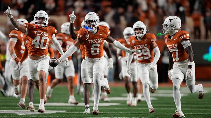 Texas Longhorns defensive back Kobe Black and teammates react after making an interception during the second half against the Texas A&M Aggies Texas Longhorns defensive back Kobe Black and teammates react after making an interception during the second half against the Texas A&M Aggies