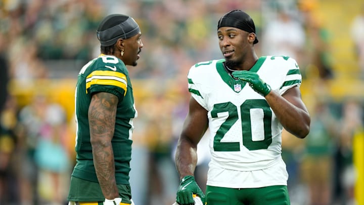 Aug 9, 2025; Green Bay, Wisconsin, USA; Green Bay Packers wide receiver Mecole Hardman (6) talks with New York Jets running back Breece Hall (20) during warmups before a preseason game at Lambeau Field. Mandatory Credit: Kayla Wolf-Imagn Images