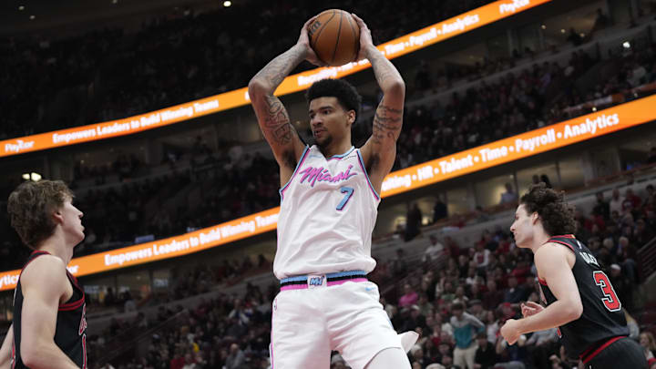 Apr 9, 2025; Chicago, Illinois, USA; Miami Heat center Kel'el Ware (7) grabs a rebound in front of Chicago Bulls guard Josh Giddey (3) during the first quarter at United Center. Mandatory Credit: David Banks-Imagn Images