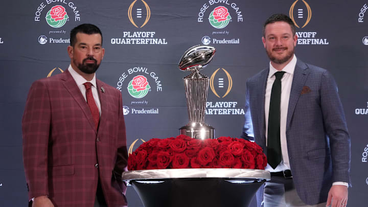 Dec 31, 2024; Los Angeles, California, USA; Ohio State Buckeyes head coach Ryan Day (left) and Oregon Ducks head coach Dan Lanning pose with the Leishman Trophy during the Rose Bowl head coaches press conference at Sheraton Grand LA. Mandatory Credit: Kirby Lee-Imagn Images