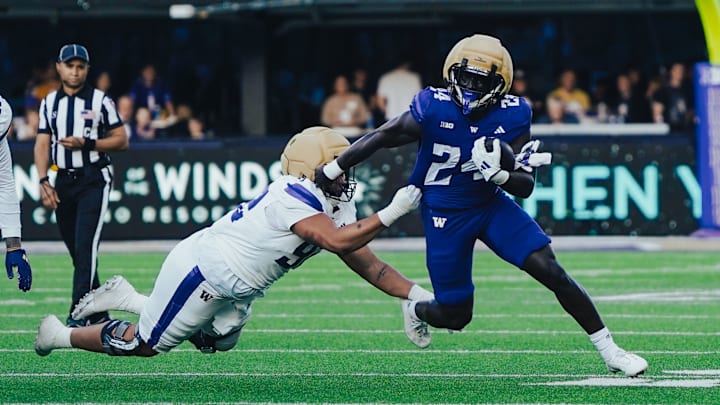 Adam Mohammed stiff arms his way upfield in the UW Spring Game. Adam Mohammed stiff arms his way upfield in the UW Spring Game.