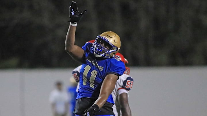 Mainland   s LJ Mccray (11) celebrates a sack during Friday night   s game against Vanguard.