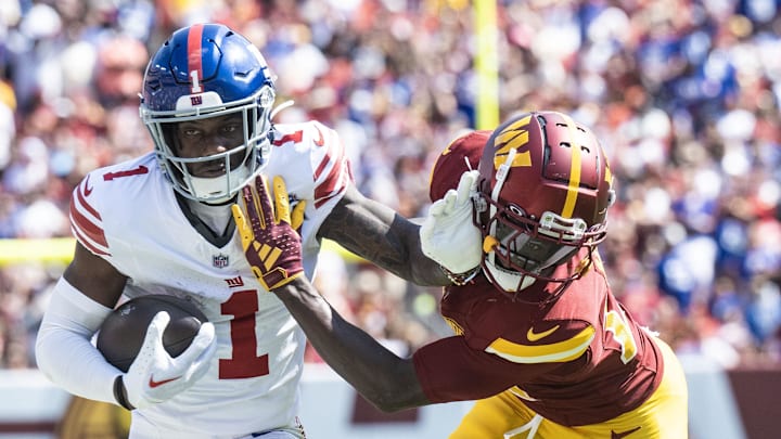 Sep 15, 2024; Landover, Maryland, USA; New York Giants wide receiver Malik Nabers (1) stiff arms Washington Commanders safety Quan Martin (20) during the first half at Commanders Field. Mandatory Credit: Luke Johnson-Imagn Images

