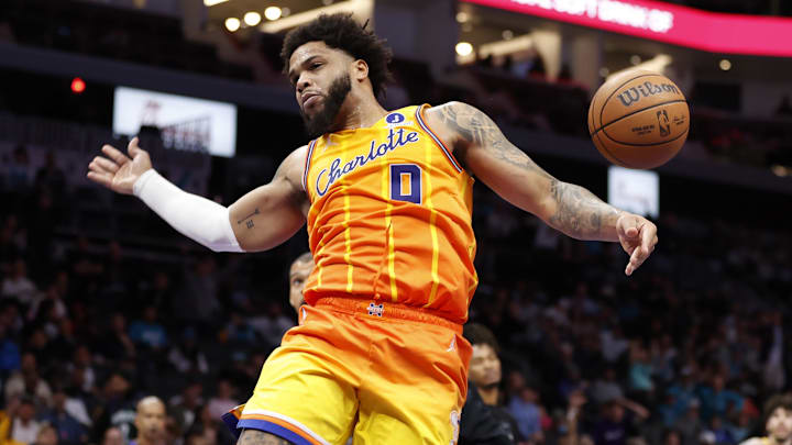 Jan 31, 2026; Charlotte, North Carolina, USA; Charlotte Hornets forward Miles Bridges (0) follows through on a slam dunk against the San Antonio Spurs during second half action at Spectrum Center. Mandatory Credit: Brian Westerholt-Imagn Images