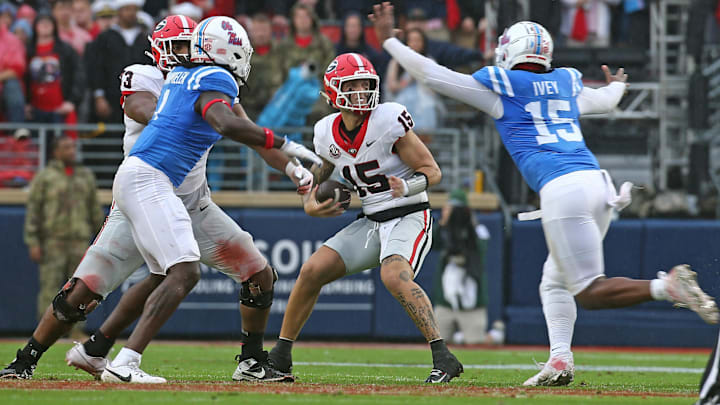 Georgia Bulldogs quarterback Carson Beck (15) drops back to pass as Mississippi Rebels defensive Jared Ivey (15) rushes during the first half at Vaught-Hemingway Stadium. Georgia has to win this week against Tennessee to keep its College Football Playoff hopes alive.