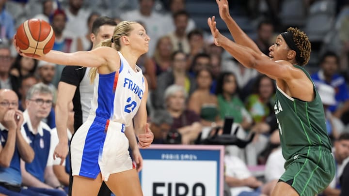 Aug 1, 2024; Villeneuve-d'Ascq, France; France shooting guard Marine Johannes (23) passes against Nigeria centre Pallas Kunaiyi-Akpanah (3) in the first half in a women’s group stage game during the Paris 2024 Olympic Summer Games at Stade Pierre-Mauroy. Mandatory Credit: John David Mercer-Imagn Images