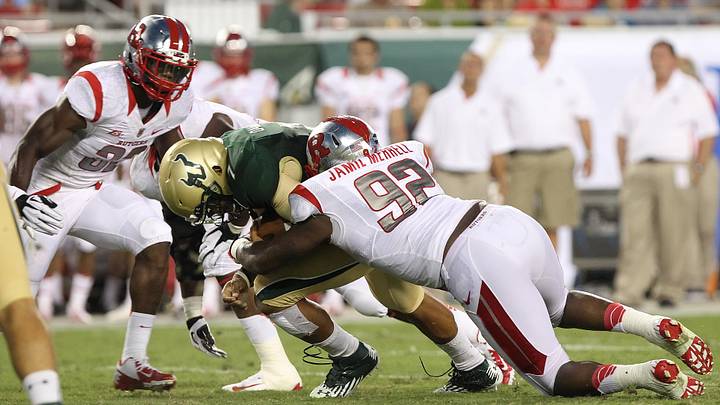 September 13, 2012; Tampa, FL, USA; South Florida Bulls quarterback B.J. Daniels (7) runs with the ball as Rutgers Scarlet Knights defensive lineman Jamil Merrell (92) tackles during the first quarter at Raymond James Stadium. Mandatory Credit: Kim Klement-USA TODAY Sports September 13, 2012; Tampa, FL, USA; South Florida Bulls quarterback B.J. Daniels (7) runs with the ball as Rutgers Scarlet Knights defensive lineman Jamil Merrell (92) tackles during the first quarter at Raymond James Stadium. Mandatory Credit: Kim Klement-USA TODAY Sports