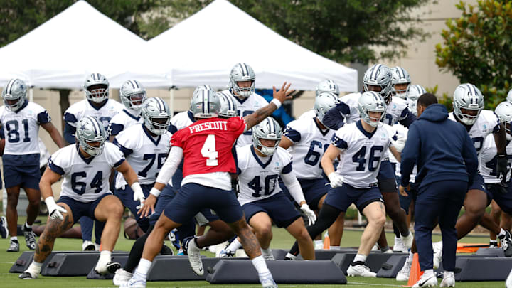 Jun 10, 2025; Arlington, TX, USA;  Dallas Cowboys quarterback Dak Prescott (4) leads teammates through a drill at the Ford Center at the Star Training Facility in Frisco, Texas. Mandatory Credit: Chris Jones-Imagn Images