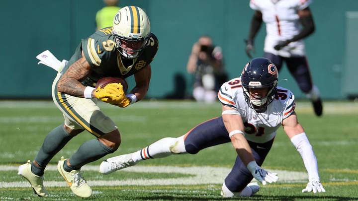 Oct 11, 2026; Green Bay, Wisconsin, USA; Green Bay Packers wide receiver Christian Watson (9) carries the ball defended by Chicago Bears safety Dillon Thieneman (31) during the third quarter at Lambeau Field. Mandatory Credit: Mike Dinovo-Imagn Images Oct 11, 2026; Green Bay, Wisconsin, USA; Green Bay Packers wide receiver Christian Watson (9) carries the ball defended by Chicago Bears safety Dillon Thieneman (31) during the third quarter at Lambeau Field. Mandatory Credit: Mike Dinovo-Imagn Images