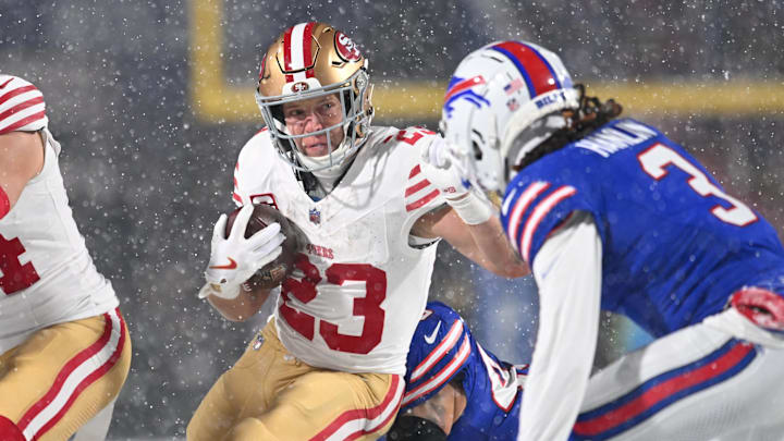 Dec 1, 2024; Orchard Park, New York, USA; San Francisco 49ers running back Christian McCaffrey (23) tries to avoid Buffalo Bills safety Damar Hamlin (3) on a run in the first quarter at Highmark Stadium. Mandatory Credit: Mark Konezny-Imagn Images