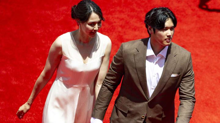 National League designated hitter Shohei Ohtani of the Los Angeles Dodgers (17) and his wife Mamiko Tanaka walk the red carpet before the 2024 MLB All-Star game at Globe Life Field.