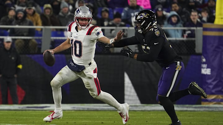 Dec 21, 2025; Baltimore, Maryland, USA;  New England Patriots quarterback Drake Maye (10) runs from Baltimore Ravens linebacker Kyle van Noy (53) during the first half of the game at M&T Bank Stadium. Mandatory Credit: James Lang-Imagn Images