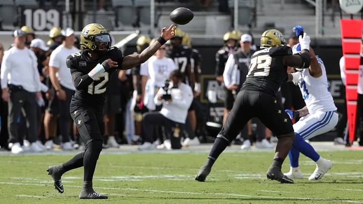 Oct 24, 2026; Orlando, Florida, USA; Central Florida Knights quarterback Keyone Jenkins (12) makes a throw against the Brigham Young Cougars during the first quarter at Acrisure Bounce House. Mandatory Credit: Mike Watters-Imagn Images Oct 24, 2026; Orlando, Florida, USA; Central Florida Knights quarterback Keyone Jenkins (12) makes a throw against the Brigham Young Cougars during the first quarter at Acrisure Bounce House. Mandatory Credit: Mike Watters-Imagn Images