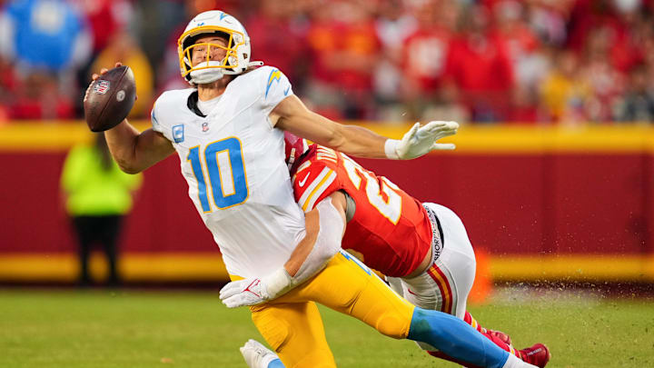Oct 22, 2023; Kansas City, Missouri, USA; Los Angeles Chargers quarterback Justin Herbert (10) is tackled by Kansas City Chiefs linebacker Drue Tranquill (23) during the second half at GEHA Field at Arrowhead Stadium. Mandatory Credit: Jay Biggerstaff-Imagn Images Oct 22, 2023; Kansas City, Missouri, USA; Los Angeles Chargers quarterback Justin Herbert (10) is tackled by Kansas City Chiefs linebacker Drue Tranquill (23) during the second half at GEHA Field at Arrowhead Stadium. Mandatory Credit: Jay Biggerstaff-Imagn Images