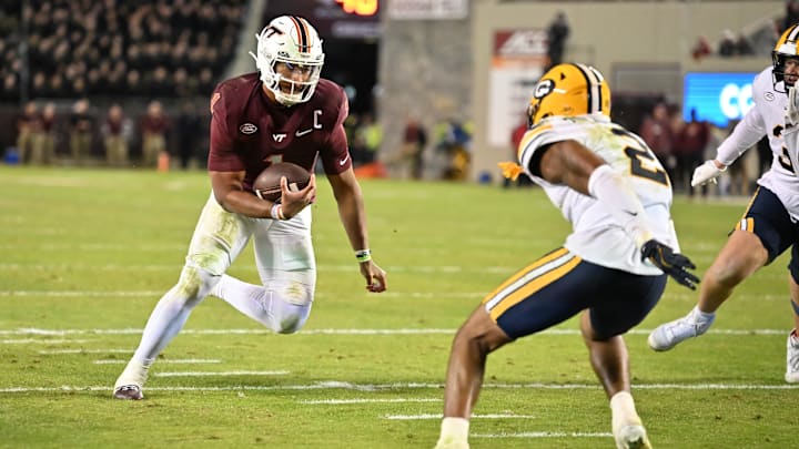 Oct 24, 2025; Blacksburg, Virginia, USA; Virginia Tech Hokies quarterback Kyron Drones (1) runs the ball for a two point conversion during the second overtime period as California Golden Bears defensive back Dru Polidore Jr. (2)defends at Lane Stadium. Mandatory Credit: Brian Bishop-Imagn Images Oct 24, 2025; Blacksburg, Virginia, USA; Virginia Tech Hokies quarterback Kyron Drones (1) runs the ball for a two point conversion during the second overtime period as California Golden Bears defensive back Dru Polidore Jr. (2)defends at Lane Stadium. Mandatory Credit: Brian Bishop-Imagn Images