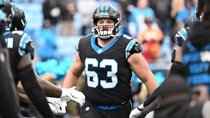 Dec 21, 2025; Charlotte, North Carolina, USA; Carolina Panthers center Austin Corbett (63) runs on to the field before the game at Bank of America Stadium. 