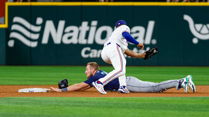 Seattle Mariners outfielder Luke Raley slides under a tag during a game against the Texas Rangers on Saturday at Globe Life Field.