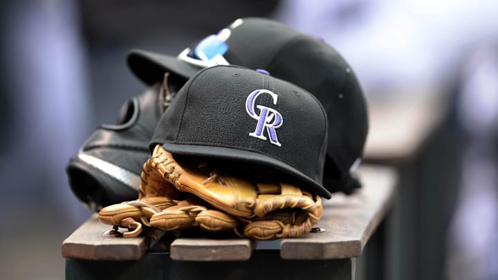 Apr 10, 2015; Denver, CO, USA; General view of Colorado Rockies hats and gloves during the eighth inning against the Chicago Cubs at Coors Field. The Rockies defeated the Cubs 5-1. Mandatory Credit: Ron Chenoy-Imagn Images
