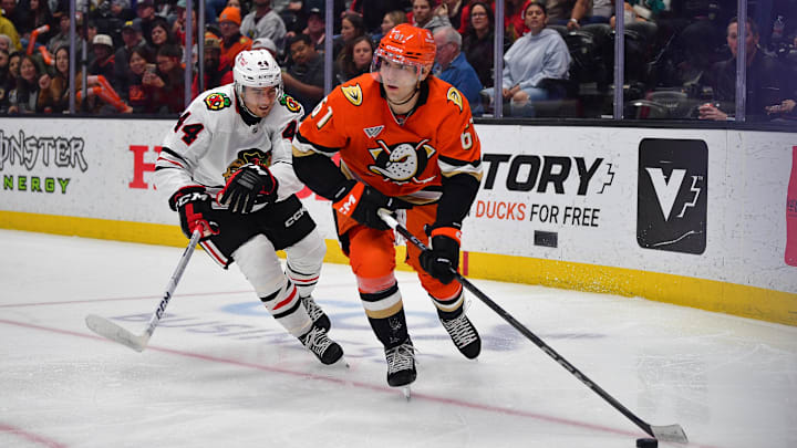 Mar 1, 2025; Anaheim, California, USA; Anaheim Ducks left wing Cutter Gauthier (61) moves the puck ahead of Chicago Blackhawks defenseman Wyatt Kaiser (44) during the second period at Honda Center. Mandatory Credit: Gary A. Vasquez-Imagn Images