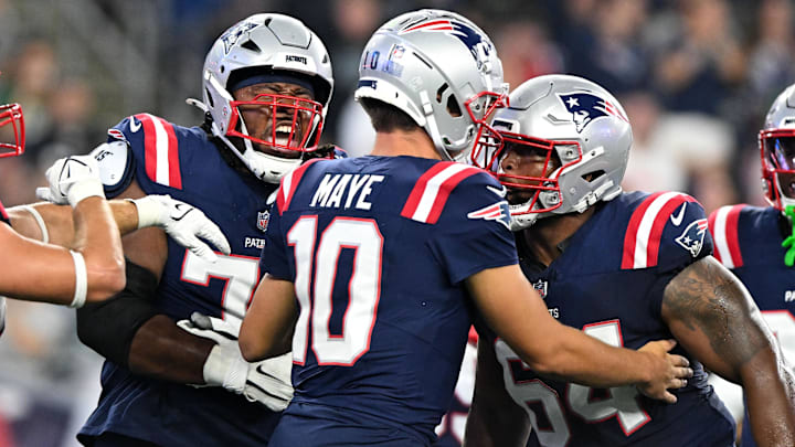 Aug 15, 2024; Foxborough, Massachusetts, USA; New England Patriots quarterback Drake Maye (10) celebrates with offensive tackle Caedan Wallace (70) and guard Layden Robinson (64) after scoring a touchdown against the Philadelphia Eagles during the first half at Gillette Stadium. Mandatory Credit: Brian Fluharty-Imagn Images