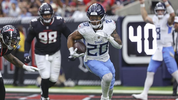 Nov 24, 2024; Houston, Texas, USA; Tennessee Titans running back Tony Pollard (20) runs with the ball during the second quarter against the Houston Texans at NRG Stadium. Mandatory Credit: Troy Taormina-Imagn Images