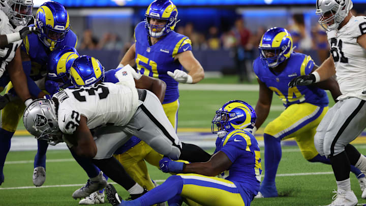 Aug 19, 2023; Inglewood, California, USA;  Los Angeles Rams linebacker DeAndre Square (58) tackles Las Vegas Raiders running back Austin Walter (32) during the third quarter at SoFi Stadium. Mandatory Credit: Kiyoshi Mio-Imagn Images