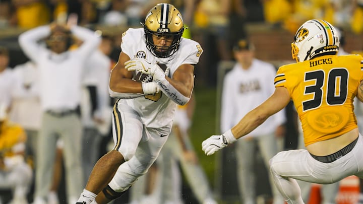 Sep 21, 2024; Columbia, Missouri, USA; Vanderbilt Commodores tight end Eli Stowers (9) runs with the ball against Missouri Tigers linebacker Chuck Hicks (30) during overtime at Faurot Field at Memorial Stadium. Mandatory Credit: Jay Biggerstaff-Imagn Images
