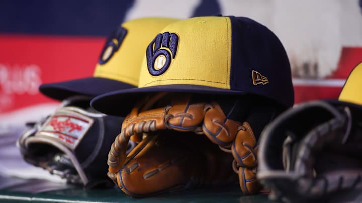 Aug 4, 2025; Atlanta, Georgia, USA; A detailed view of a Milwaukee Brewers hat and glove in the dugout against the Atlanta Braves in the fourth inning at Truist Park. Mandatory Credit: Brett Davis-Imagn Images