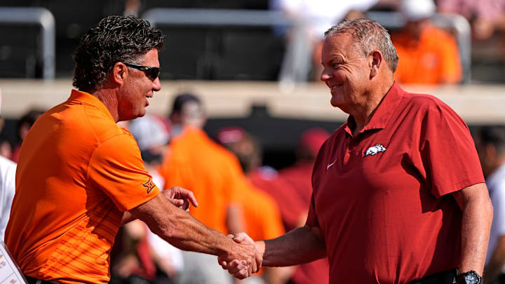 Oklahoma State head coach Mike Gundy shakes hands with Arkansas head coach Sam Pittman before the college football game between the Oklahoma State Cowboys and the Arkansas Razorbacks at Boone Pickens Stadium in Stillwater, Okla.,, Saturday, Sept., 7, 2024. Oklahoma State head coach Mike Gundy shakes hands with Arkansas head coach Sam Pittman before the college football game between the Oklahoma State Cowboys and the Arkansas Razorbacks at Boone Pickens Stadium in Stillwater, Okla.,, Saturday, Sept., 7, 2024.