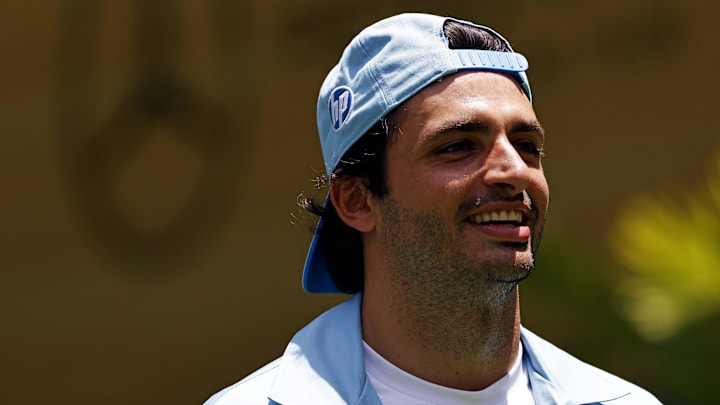 May 2, 2024; Miami Gardens, Florida, USA; Ferrari driver Carlos Sainz (55) takes part in a NFL football punt catch challenge alongside Miami Dolphins players in advance of the F1 Miami Grand Prix at the Miami International Autodrome. Mandatory Credit: Peter Casey-USA TODAY Sports