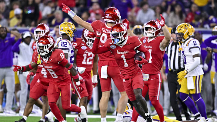Dec 27, 2025; Houston, TX, USA; Houston Cougars defensive back Latrell McCutchin Sr. (1) recovers the onside kick during the second half against the Louisiana State Tigers at NRG Stadium. 