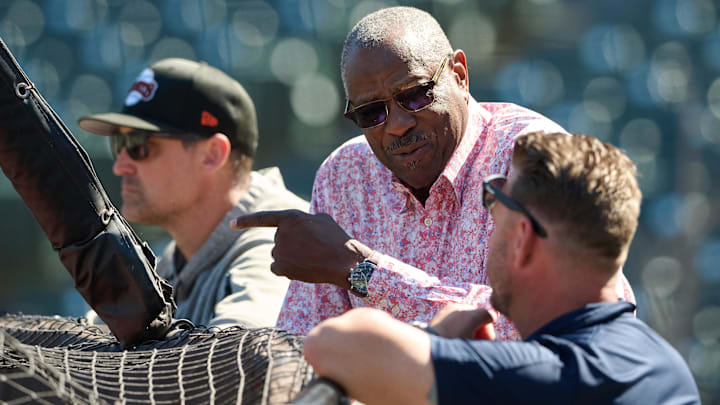 San Francisco Giants special advisor to baseball operations Dusty Baker chats with a Washington Nationals staff member as San Francisco Giants hitting coach Pat Burrell (95) looks on during batting practice before the game at Oracle Park. 