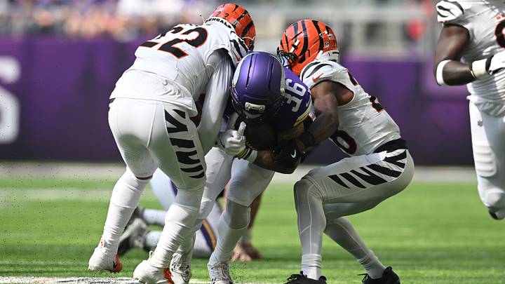 Minnesota Vikings running back Zavier Scott (36) is tackled by Cincinnati Bengals safety Geno Stone (22) and cornerback Josh Newton (28) during the first half at U.S. Bank Stadium. Mandatory Credit: Jeffrey Becker-Imagn Images