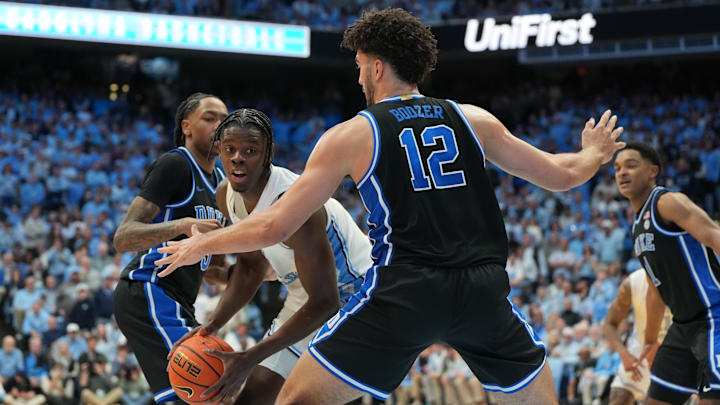Feb 7, 2026; Chapel Hill, North Carolina, USA; North Carolina Tar Heels forward Caleb Wilson (8) with the ball as Duke Blue Devils forward Cameron Boozer (12) defends.