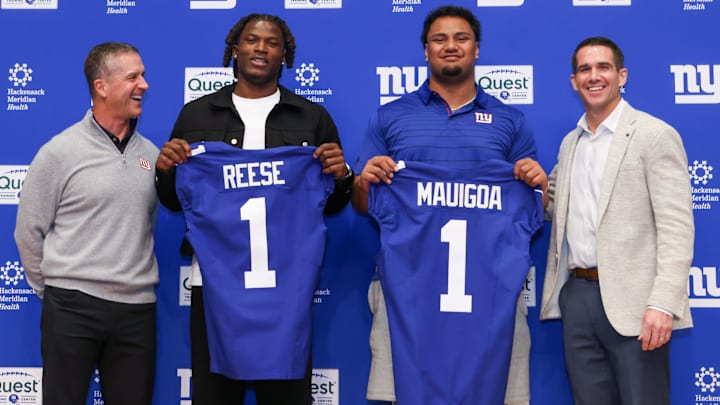 New York Giants draft picks Arvell Reese and Francis Mauigoa, Head Coach John Harbaugh (left) and General Manager Joe Schoen  (right)