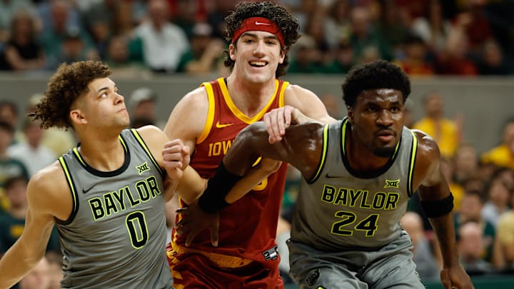Jan 7, 2026; Waco, Texas, USA;  Iowa State Cyclones forward Blake Buchanan (23) battles for position between Baylor Bears guard Dan Skillings Jr. (0) and guard Tounde Yessoufou (24) during the first half at Paul and Alejandra Foster Pavilion.