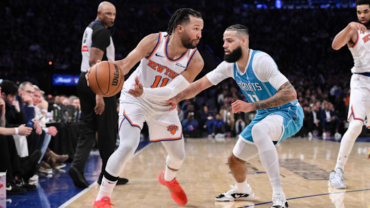 Dec 5, 2024; New York, New York, USA; New York Knicks guard Jalen Brunson (11) passes the ball as Charlotte Hornets forward Cody Martin (11) defends during the second half at Madison Square Garden. Mandatory Credit: John Jones-Imagn Images