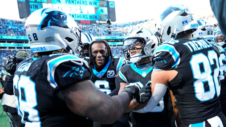 Dec 22, 2024; Charlotte, North Carolina, USA; Carolina Panthers running back Chuba Hubbard (30) celebrates with guard Damien Lewis (68) and cornerback Jaycee Horn (8) and tight end Tommy Tremble (82) after scoring a touchdown to win the game in overtime at Bank of America Stadium. Mandatory Credit: Bob Donnan-Imagn Images