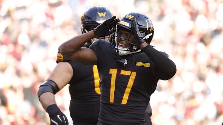 Dec 1, 2024; Landover, Maryland, USA; Washington Commanders wide receiver Terry McLaurin (17) celebrates with fans in the stands after scoring a touchdown against Tennessee Titans during the first half at Northwest Stadium. Mandatory Credit: Amber Searls-Imagn Images