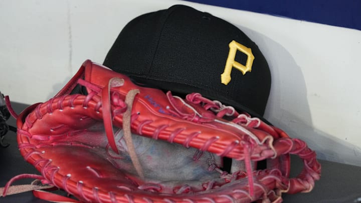 Jun 23, 2025; Milwaukee, Wisconsin, USA; against the Pittsburgh Pirates hat and glove in the dugout before a game against the Milwaukee Brewers at American Family Field. Mandatory Credit: Michael McLoone-Imagn Images