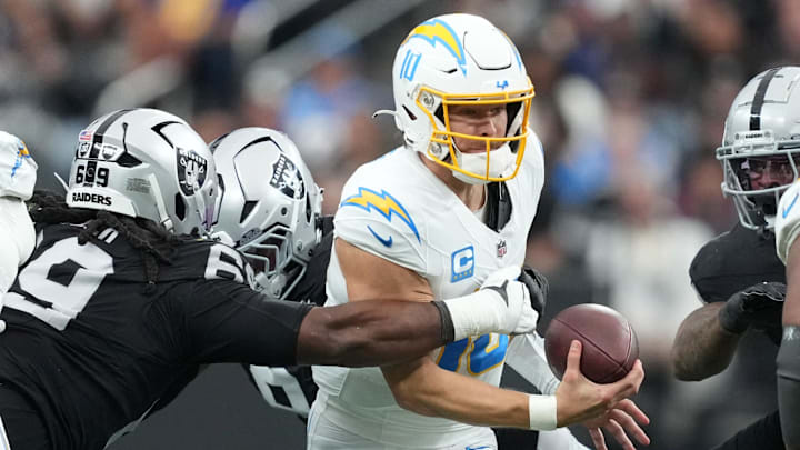 Jan 5, 2025; Paradise, Nevada, USA; Los Angeles Chargers quarterback Justin Herbert (10) is sacked by Las Vegas Raiders defensive tackle Adam Butler (69) in the first half at Allegiant Stadium. Mandatory Credit: Kirby Lee-Imagn Images Jan 5, 2025; Paradise, Nevada, USA; Los Angeles Chargers quarterback Justin Herbert (10) is sacked by Las Vegas Raiders defensive tackle Adam Butler (69) in the first half at Allegiant Stadium. Mandatory Credit: Kirby Lee-Imagn Images