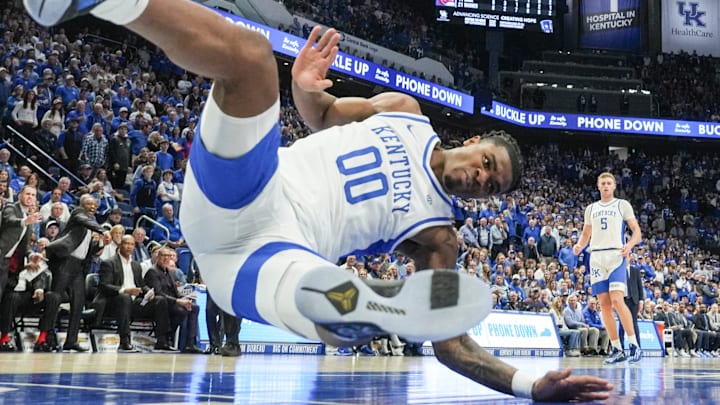 Arkansas Razorbacks forward Karter Knox (11) slams down two as Kentucky Wildcats guard Otega Oweh (00) falls to the ground in the Wildcats' 89-79 loss to the Hogs Saturday Feb. 1, 2025 at Rupp Arena in Lexington, Kentucky.