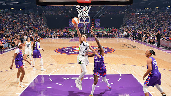 Olivia Miles (center) had 13 points, seven assists and six rebounds as Minnesota got its first win of the season against the Mercury on Tuesday.