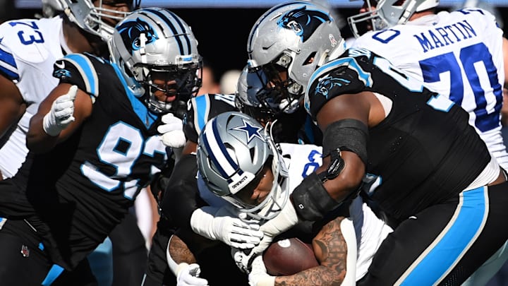 Nov 19, 2023; Charlotte, North Carolina, USA; Dallas Cowboys running back Rico Dowdle (23) is tackled by Carolina Panthers defensive tackles LaBryan Ray (93) and Derrick Brown (95) in the second quarter at Bank of America Stadium. Nov 19, 2023; Charlotte, North Carolina, USA; Dallas Cowboys running back Rico Dowdle (23) is tackled by Carolina Panthers defensive tackles LaBryan Ray (93) and Derrick Brown (95) in the second quarter at Bank of America Stadium.