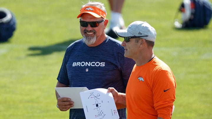 Jul 28, 2023; Englewood, CO, USA; Denver Broncos inside linebackers coach Greg Manusky (L) and special teams coordinator Ben Kotwika (R) during training camp at Centura Health Training Center. Jul 28, 2023; Englewood, CO, USA; Denver Broncos inside linebackers coach Greg Manusky (L) and special teams coordinator Ben Kotwika (R) during training camp at Centura Health Training Center.