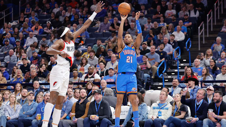 Mar 7, 2025; Oklahoma City, Oklahoma, USA; Oklahoma City Thunder guard Aaron Wiggins (21) shoots a three point basket as Portland Trail Blazers forward Jerami Grant (9) defends during the second quarter at Paycom Center. Mandatory Credit: Alonzo Adams-Imagn Images