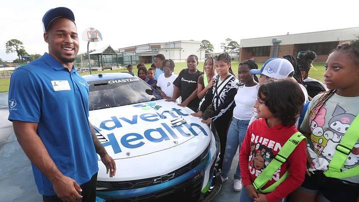 Journey Brown (left), a former Penn State football player and high school football state record-setter, became the front tire changer on Ross Chastain's No. 1 AdventHealth Chevrolet race car.