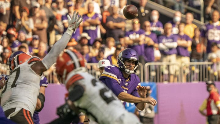 Minnesota Vikings quarterback Kirk Cousins (8) fires off an incomplete pass through a crowd of Cleveland Browns players at U.S. Bank Stadium.